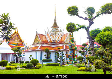 Die klösterliche Viertel Komplexe mit riesigen Dämon zahlen und formgehölze Bäume am Wat Arun (Tempel der Morgenröte) in Bangkok, Thailand Stockfoto