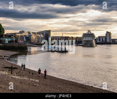 London,Greenwich.MV Viking cruise Liner, touristischen Schiff vor Anker am Thames River mit Wolken bei Sonnenuntergang. Menschen auf exponierten Fluss Bett Strand bei Ebbe Stockfoto