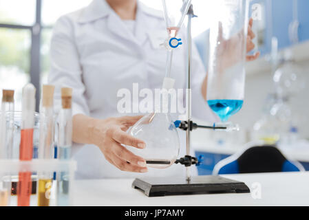 Schöne weibliche Wissenschaftler hält eine Flasche Stockfoto