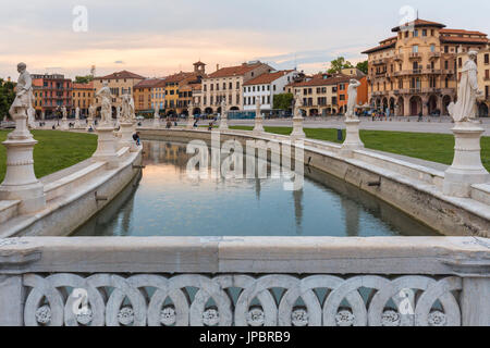 Ein Überblick der Prato della Valle in Padua, Italien mit den Statuen entlang des Kanals spiegeln sich in das Stille Wasser zusammen mit den umliegenden historischen Gebäuden, Veneto, Italien, Europa Stockfoto