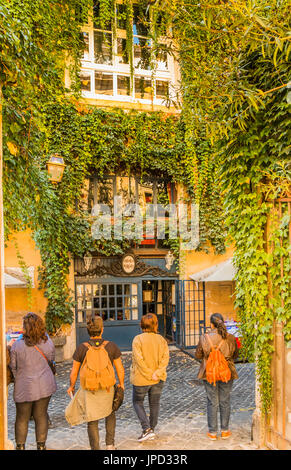 Touristen warten mit zugewachsenen Fassade der Osteria Margutta im Hintergrund Stockfoto