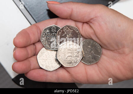 Beatrix Potter Sammler britischen fünfzig Pence Münzen in Umlauf Jemima Pratschel-Watschel Frau tiggy-Winkle Eichhörnchen Nusper Womans Hand Stockfoto