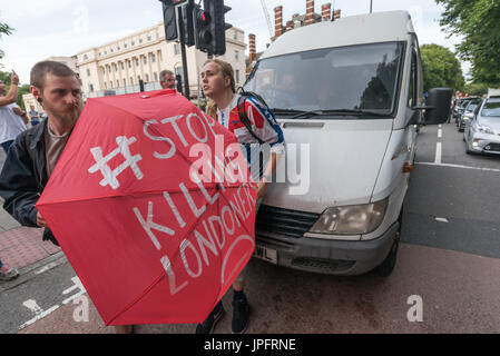 London, UK. 1. August 2017. Ein Mann in einem weißen Lieferwagen schleudert Wasser die Demonstranten, nachdem sie sich geweigert haben, zu bewegen, wenn er versucht, fahren durch den Rising Up Umwelt Demonstranten Blockiing Verkehr auf der belebten Marylebone Road unweit von Baker St für einen zweiten "Staying Alive" Straßensperre Disco Protest zu sensibilisieren und rufen zu dringendem Handeln über die hohe Schadstoffbelastung von Verkehr auf den Straßen Londons, die 10.000 vorzeitige Todesfälle pro Jahr verursachen. Sie standen und saßen auf der Straße vor dem Wagen und schob ihn zurück, als er versuchte, befahren.  Peter Marshall/Alamy Live-Nachrichten Stockfoto