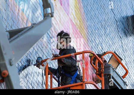 Künstlers Eduardo Kobra ist abgebildet, wie er auf eine Riesen große John Lennon-Wandbild am Upfest 2017, Europas größte frei, street Art & Graffiti-Festival funktioniert Stockfoto