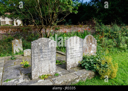 Grabsteine von Austens Mutter und Schwester Cassandra im Kirchhof von der Pfarrkirche St. Nikolaus, Chawton, Hampshire, Südengland, Großbritannien Stockfoto