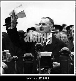 Neville Chamberlain 1938 hält das „Stück“ stolz hoch, das sowohl Hitler als auch er selbst bei seiner Rückkehr von München zum Heston Aerodrome 1938 mit dem Zitat unterzeichnet haben: „Der Wunsch, nie wieder in den Krieg zu ziehen...!“ Stockfoto