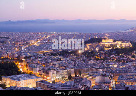 Blick auf die Stadt von Athen, während des Sonnenuntergangs. Auf der rechten Seite kann gesehene Akropolis und das Parthenon, und unten links das griechische Parlament. Stockfoto