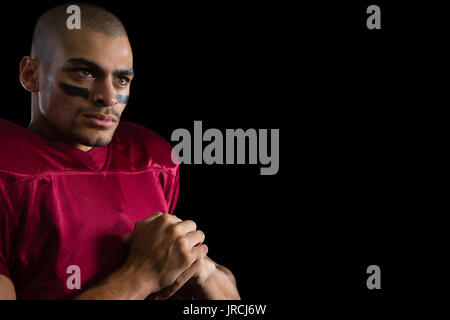 Close-up bestimmt American football player auf schwarzem Hintergrund Stockfoto