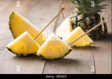geschnittene Ananas auf Holz Hintergrund, beliebte Frucht in der Sommersaison Stockfoto