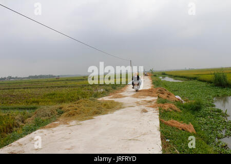 HAI DUONG, VIETNAM, AUGUST, 20.: asiatische Frau auf einem Fahrrad auf der Straße am August 20, 2014 in Hai Duong, Vietnam. Stockfoto