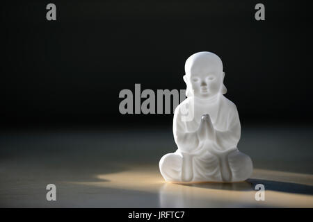 Kunststoff klein Buddha Skulptur auf dem Tisch Stockfoto