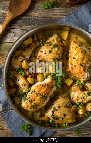 Hausgemachte gebackenes Huhn Vesuvio mit Erbsen und Kartoffeln Stockfoto
