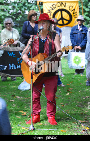 London, UK. 6. August 2017. Peter Dunne (Volkssänger) singen bei der Kampagne für nukleare Abrüstung jährliche Gedenken an die Atombombenabwürfe auf Hiroshima, Japan am Tavistock Square, London, Vereinigtes Königreich.  Am 6. August 1967 war ein Kirschbaum auf dem Platz von Camden Rat in Gedenken an die Opfer der Bombardierung gepflanzt. Seither hat eine jährliche Zeremonie um den Baum zu erinnern, den Angriff statt. Bildnachweis: Michael Preston/Alamy Live-Nachrichten Stockfoto