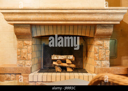 Das schön eingerichtete Kamin mit Brennholz. Stockfoto