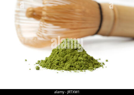 Haufen von pulverförmigen Green Matcha Tee und Chasen auf weißem Hintergrund Stockfoto