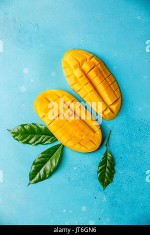 Rohe frische geschnittene Mango auf blauem Hintergrund Stockfoto