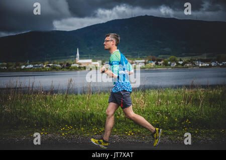 CARLETON, Kanada - 4. Juni 2017. In der fünften Marathon von Carleton in Québec, Kanada. Einsamer Mann an der Spitze einer Gruppe von 10 K Läufer Stockfoto