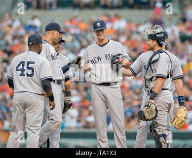 New York Yankees Krug Shane Greene (61), zentrieren, ist von seinen Teamkameraden gratulierte, nachdem er seine letzte Teig im achten Inning gegen die Baltimore Orioles im Oriole Park at Camden Yards in Baltimore, MD am 12. Juli 2014 konfrontiert. Greene im Ruhestand Oriole Entscheidungsspiel Steve Clevenger, die erste, in der achten zu sichern, bevor er ersetzt wurde.  Die Yankees gewann das Spiel 3: 0.  Von links nach rechts: dritte Baseman Zelous Wheeler (45), Shortstop Derek Jeter (2), zweiter Basisspieler Brian Roberts (14), Greene, Catcher Francisco Cervelli (29) und erster Basisspieler Mark Teixeira (25). Bildnachweis: Ron Sachs / CN Stockfoto
