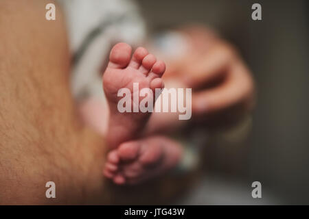 Gerne Vater mit niedlichen Baby feets Stockfoto