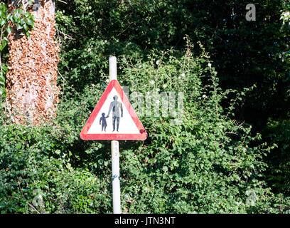 Ein rotes Dreieck Straße Straßenschild mit einem Mann und Kind Sicherheit Warnung; UK Stockfoto