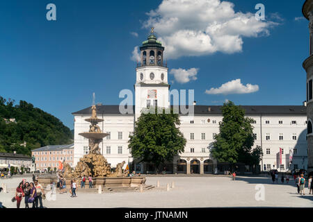 Residenzbrunnen und der Turm mit dem Glockenspiel der Neuen Residenz auf dem Residenzplatz in Salzburg, Österreich | Brunnen Residenzbrunnen und die Neue Stockfoto