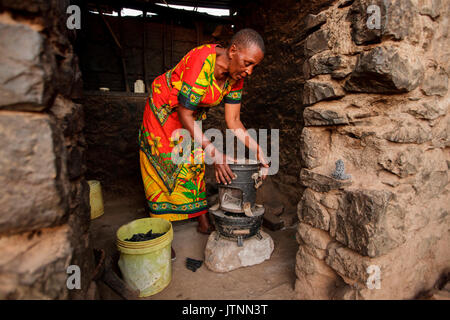 Solar Schwester Unternehmer Julieth Mollel, 61, bereitet das Abendessen auf Sie sauber cookstove an ihrem Haus in der Nähe von Arusha, Tansania zu kochen. Julieth Mollel steht, wenn sie sagt, sie ist eine solare Schwester Unternehmer und Ihren Erfolg beim Verkauf der Laternen und cookstoves gegeben ihre Hoffnung für ihre Zukunft hat und Stockfoto