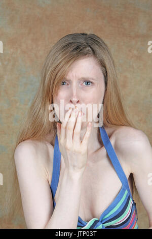 Junge Frau Gefühl Kranken die Hand über Mund Stockfoto