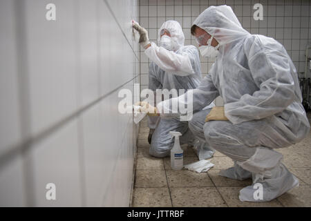 Kassel, Deutschland. 2 Aug, 2017. Tatort Reiniger Sinisa (L) und David Matokovic sauber eine Wand für eine gestellte Foto in Kassel, Deutschland, 2. August 2017. Foto: Swen Pförtner/dpa/Alamy leben Nachrichten Stockfoto