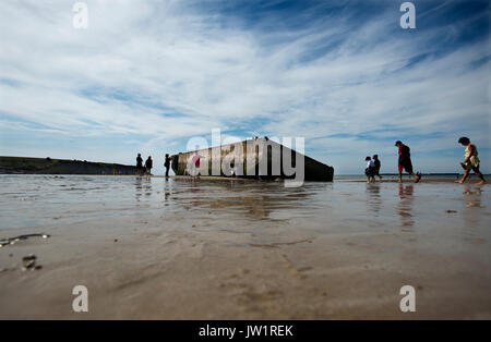 Arromanches-les-Bain, Cavados, Normandie, Frankreich. August 2017 Überreste des Zweiten Weltkriegs Mulberry Hafen am Strand von Arromanches. Bei Ebbe Stockfoto