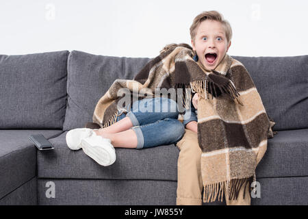 Angst junge Fernsehen mit Schwester versteckt unter Decke isoliert auf weißem Stockfoto