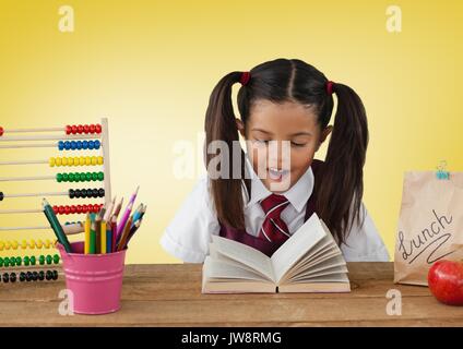 Digital composite der Schülerin an Schreibtisch vor gelbem Hintergrund mit Abacus und Buch Stockfoto