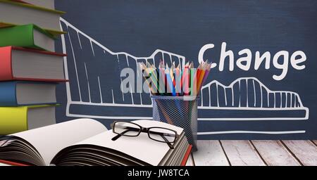 Digital composite der Bücher auf den Tisch gegen blaue Tafel mit Bildung und Schule Grafiken Stockfoto