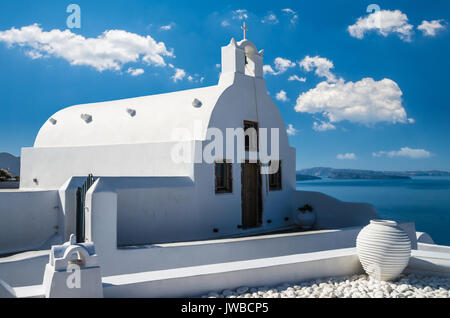 Das Dorf Oia, Santorini, Kykladen, Griechenland. Wunderschöne Aussicht auf eine weisse Kirche in Caldera. Stockfoto