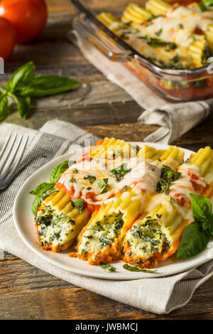 Hausgemachte gefüllt mit Ricotta und Spinat Manicotti mit Basilikum Stockfoto