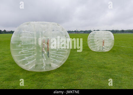 Two big bumper-balls on a green lawn, ready for soccer playing, a new funsport in Copenhagen, Denmark - July 27, 2017 Stockfoto