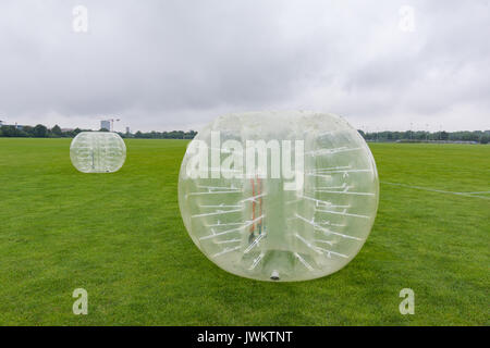 Two big inflatable knocker balls on the lawn for soccer playing, the new funsport in Copenhagen Stockfoto