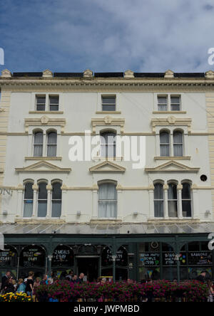 Weiß gerenderte Gebäudefassade mit Glas- und gusseiserner Veranda in llandudno, Nord-wales, großbritannien Stockfoto