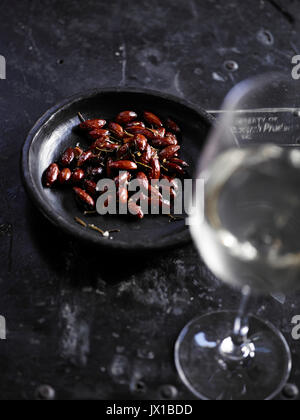 Gebrannte Mandeln und ein Glas Wein Stockfoto