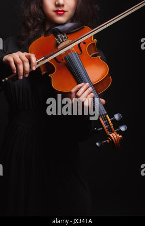 Musikalische Konzept. Eine Frau spielt die Geige. Fokus auf der Violine Stockfoto