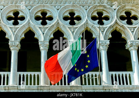 Italienische und europäische Flaggen im Dogenpalast, venezianischer Gotik. Markusplatz. UNESCO. Palazzo Ducale, Piazza San Marco. Venedig, Italien Europa Stockfoto