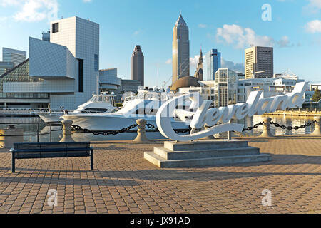 Blick von der Nordküste Hafen am Erie See von Downtown Cleveland, Ohio, USA zeigt die dynamischen Skyline und im Vordergrund steht die 'Cleveland' Zeichen Stockfoto