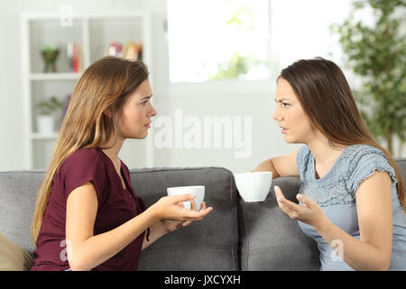 Zwei Freunde reden ernsthaft sitzen auf einer Couch zu Hause Stockfoto