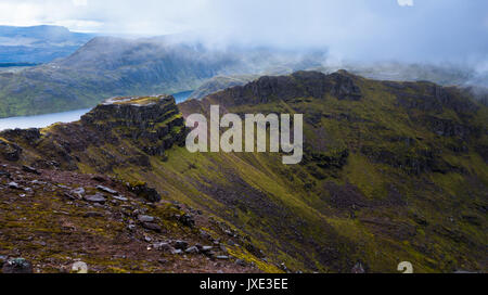 Majestic Mountain ridge und Plateau unterhalb der Munro peak Beinn Tarsuinn im Fisherfield Forest mit dahintreibenden Wolken und Felsen und Heather si abgedeckt Stockfoto