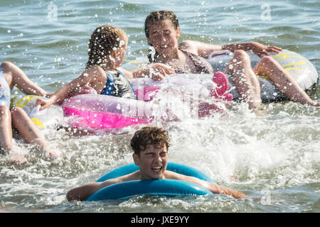 West Bay, Dorset, Großbritannien. 15 August, 2017. UK Wetter: Urlauber und Einheimische genießen Sie einen heißen sonnigen Nachmittag, Sonnenbaden und Schwimmen am Strand von West Bay. Foto Credit: Guy Corbishley/Alamy leben Nachrichten Stockfoto