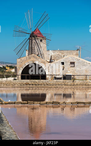 Windmühlen und Salinen im Museum von Salz, in der Nähe von Nubien, südlich von Trapani, an der Westküste von Sizilien, Italien. Stockfoto