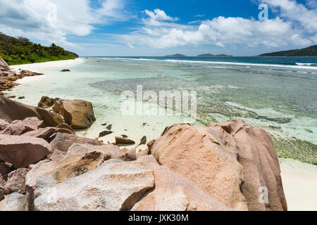 Anse Grosse Roche im Osten von La Digue, Seychellen mit klarem Wasser und Granit Felsen Stockfoto