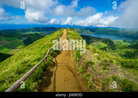 Weg entlang der Miradouro Da Boca do Inferno (Aussichtspunkt), mit Lagoa Verde und Lagoa Azul und das Meer im Hintergrund. Sete Cidades, Azoren Stockfoto