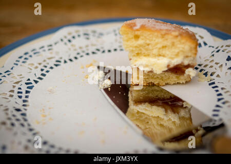 Die letzte Schicht Marmelade und Sahne Biskuitböden auf einem Papier dolly Stockfoto