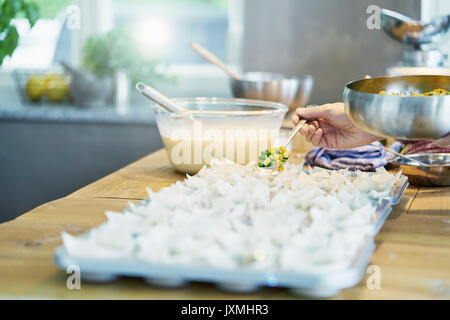 Koch spooning Gemüse in Blätterteig Formen, close-up Stockfoto