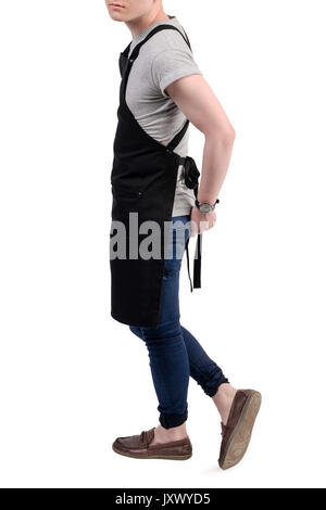 Junge Koch oder Kellner posiert, tragen, Schürze und grauen T-Shirt auf weißem Hintergrund. Barista Café Kaffee uniform. Stockfoto